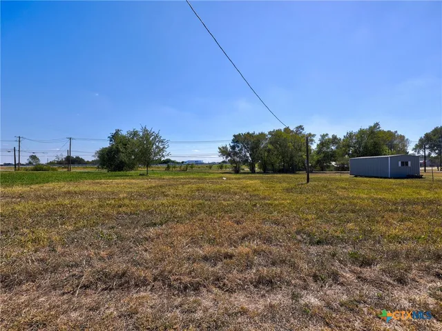 a view of a field with an ocean view