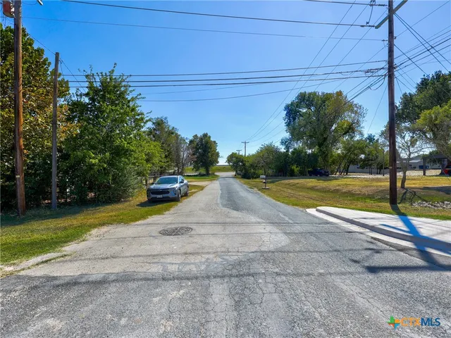 a view of a street with a play house in the background
