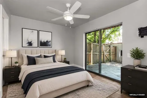 a bedroom with a large bed and a large window