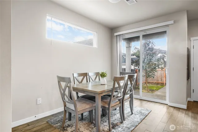 a dining room with furniture and wooden floor