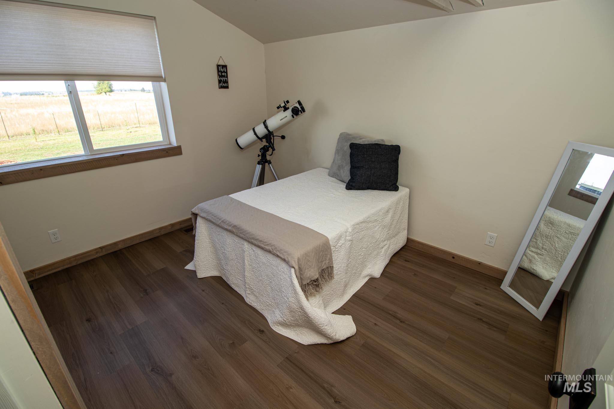 263 Glory Lane Orofino, ID 83544 - Photo 28 of 48 Bedroom with lofted ceiling and dark wood-style flooring