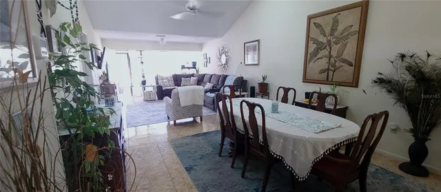 a view of a a dining room with furniture and a potted plant