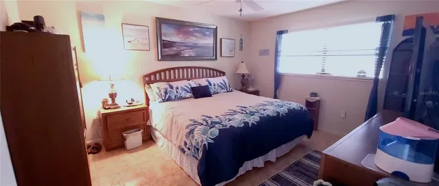 a bedroom with a bed and a mirror