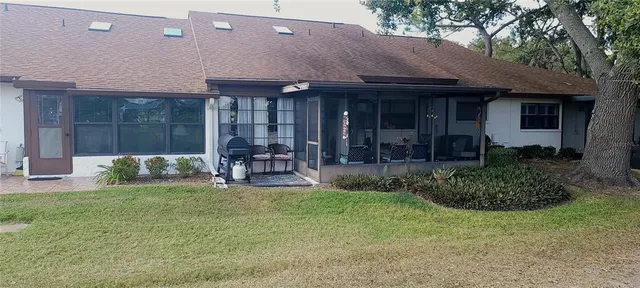 a view of a house with a yard and sitting area