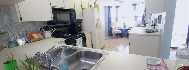 a kitchen with a refrigerator and a stove top oven