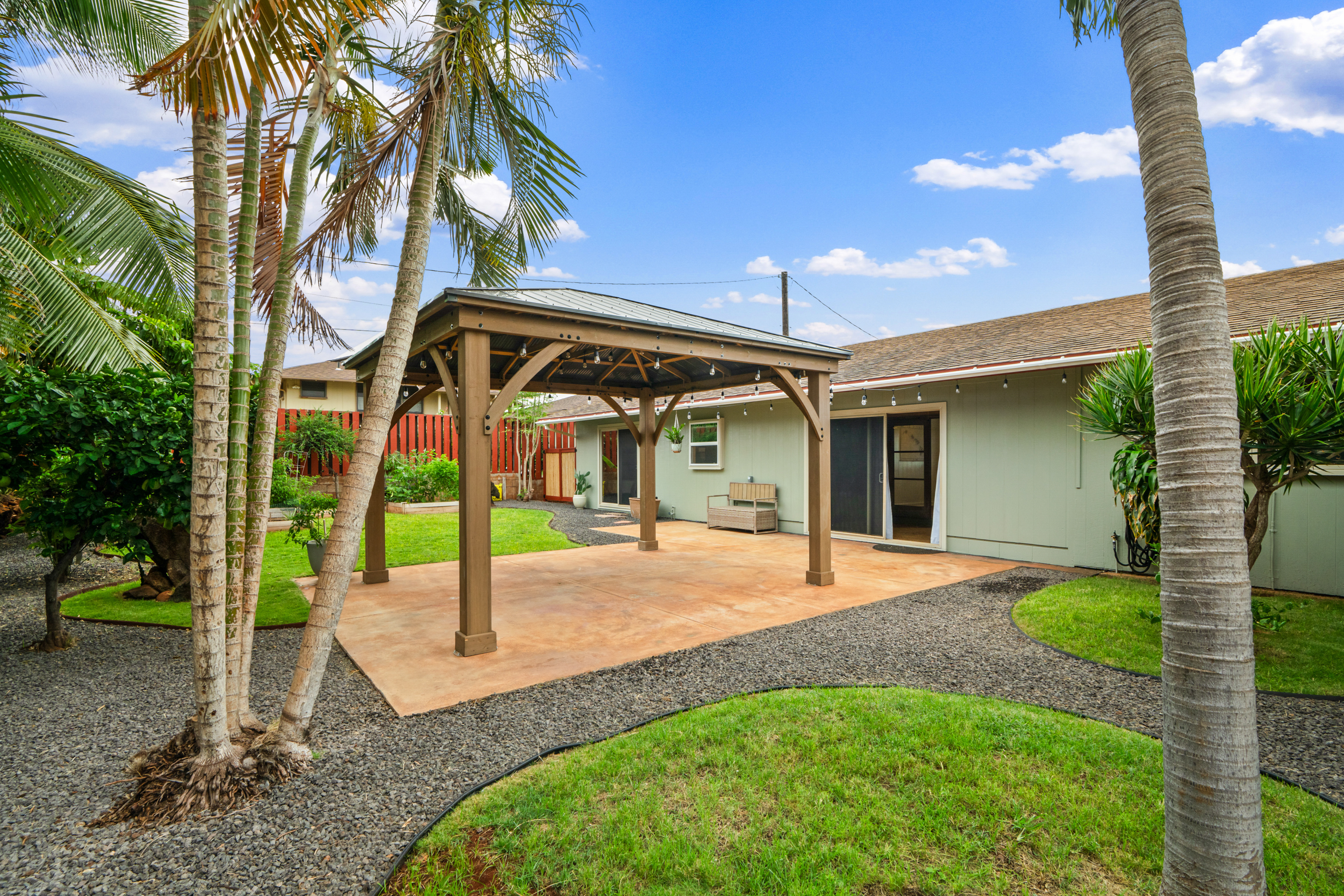 9639 Maule Road Waimea, HI 96796 - Photo 1 of 29 a view of a house with a yard and palm trees
