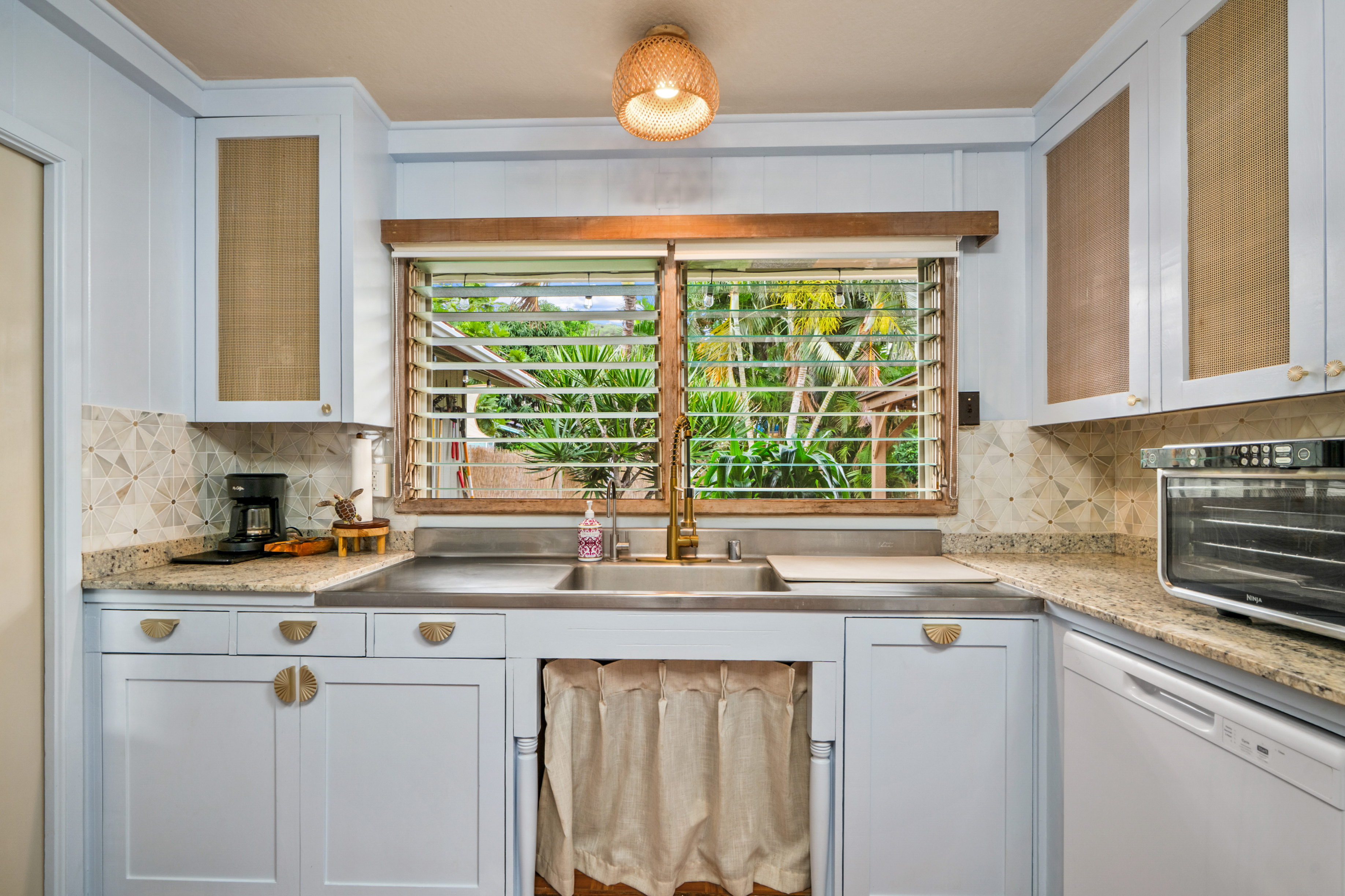 9639 Maule Road Waimea, HI 96796 - Photo 2 of 29 a kitchen with stainless steel appliances a sink a stove and a window