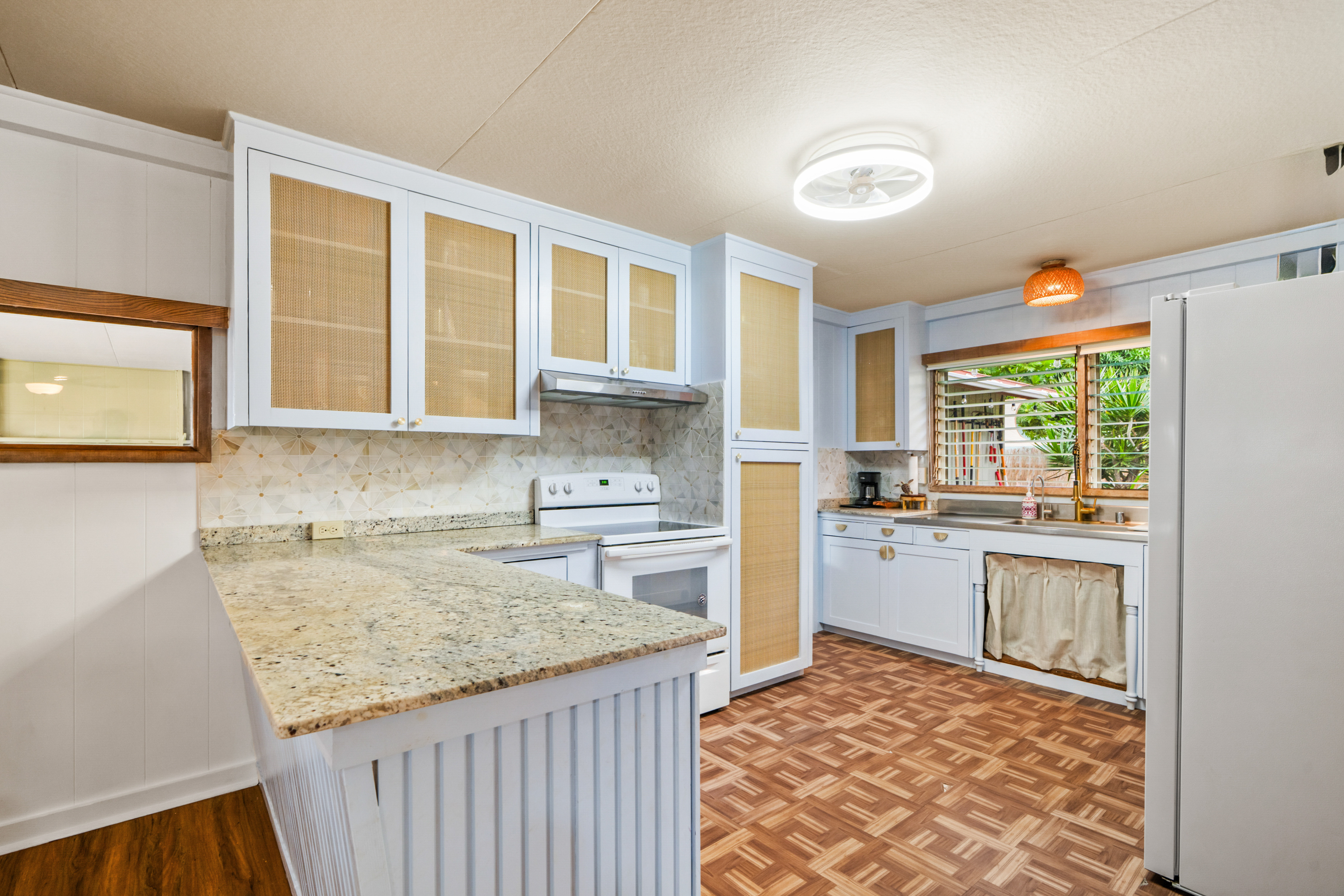 9639 Maule Road Waimea, HI 96796 - Photo 6 of 29 a kitchen with a stove a sink and a refrigerator