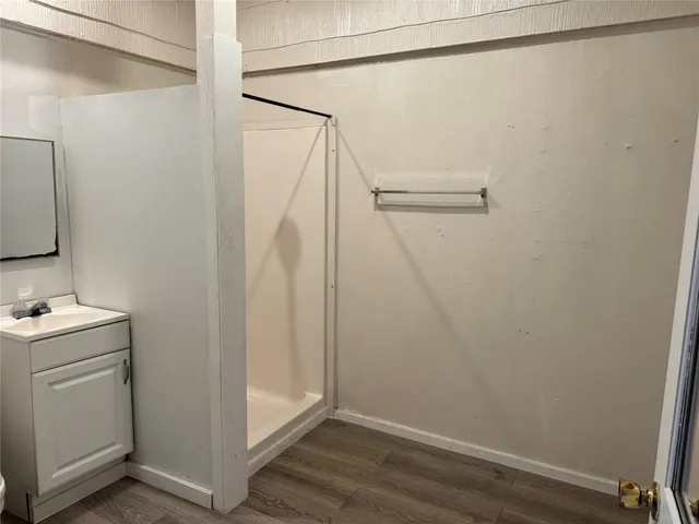 a view of walk in closet with wooden floor