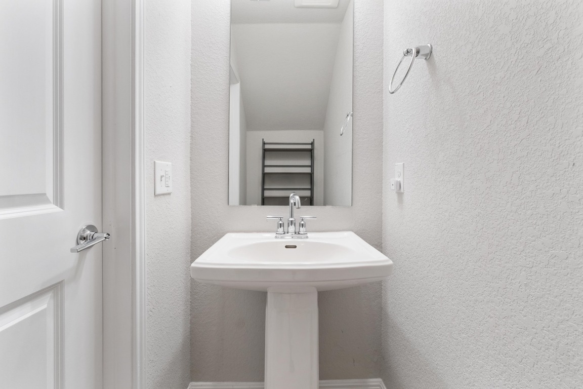 9015 Cattle Baron Path, Unit 1905 Austin, TX 78747 - Photo 13 of 40 a bathroom with a sink a mirror and shower