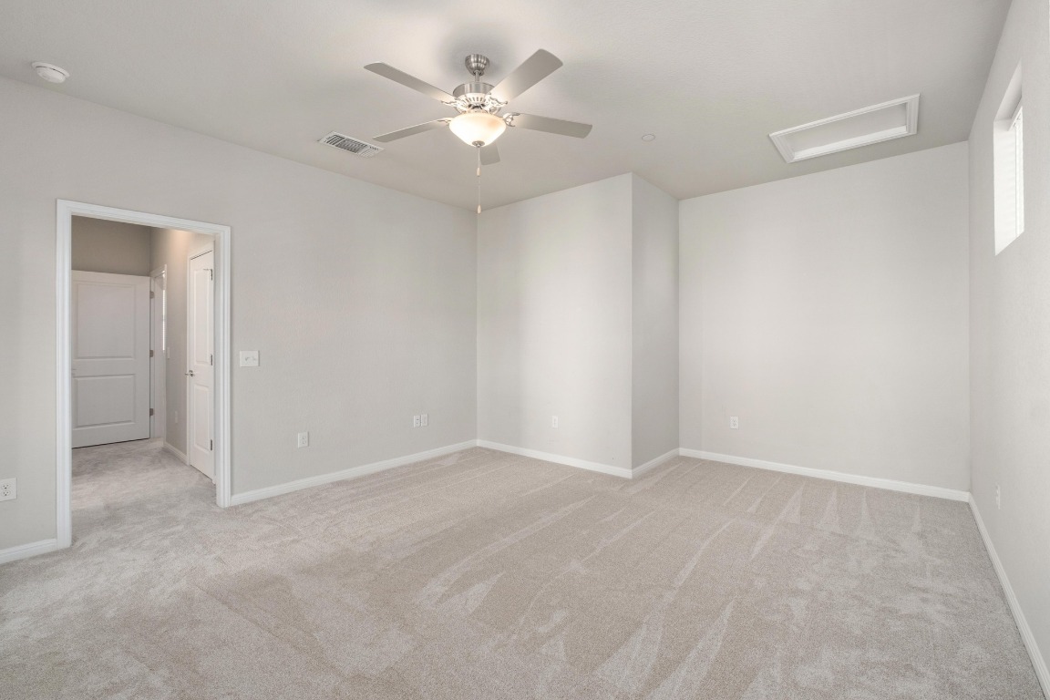 9015 Cattle Baron Path, Unit 1905 Austin, TX 78747 - Photo 16 of 40 an empty room with a ceiling fan and a window