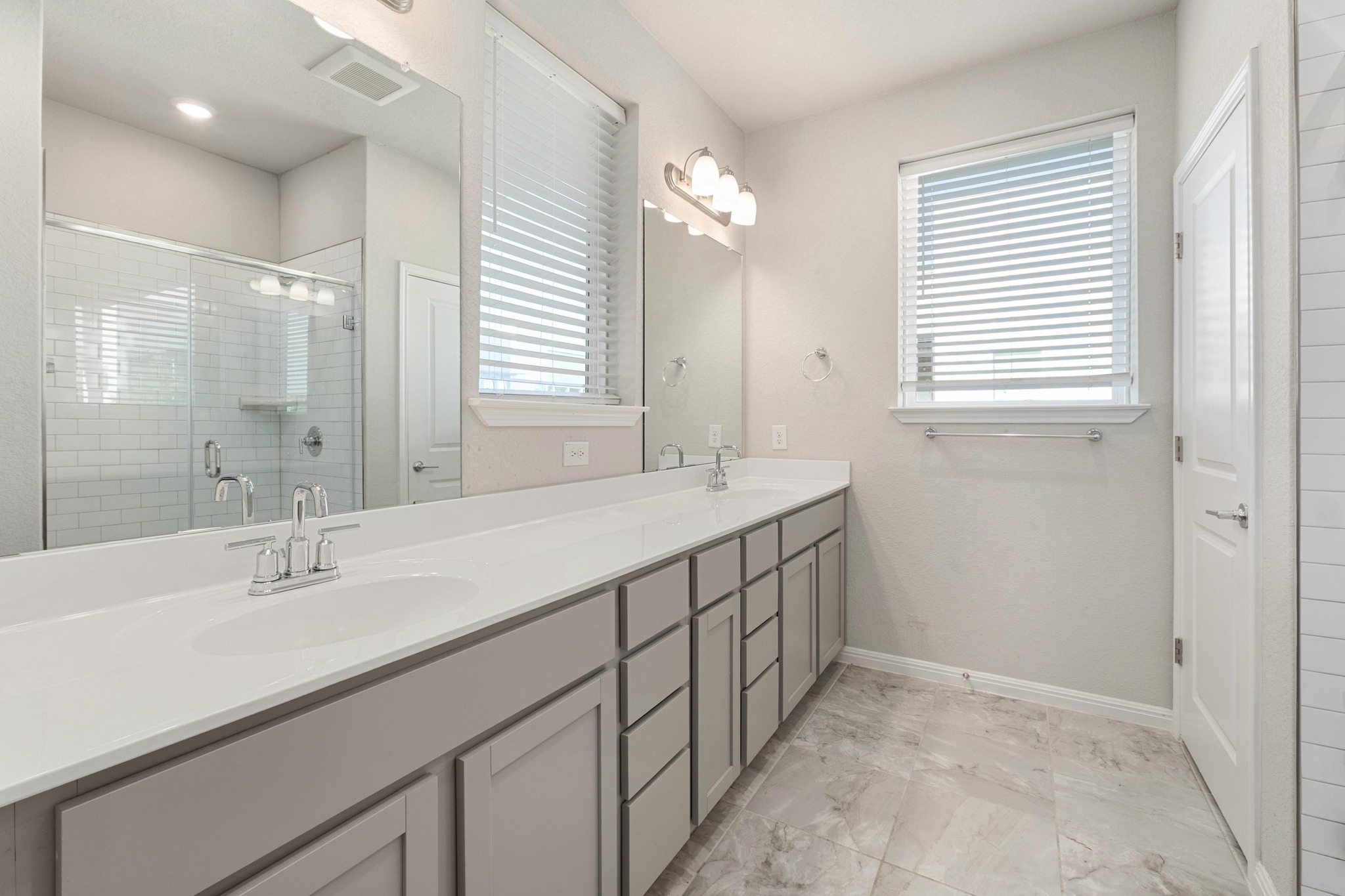 9015 Cattle Baron Path, Unit 1905 Austin, TX 78747 - Photo 20 of 40 a bathroom with double sink and a mirror