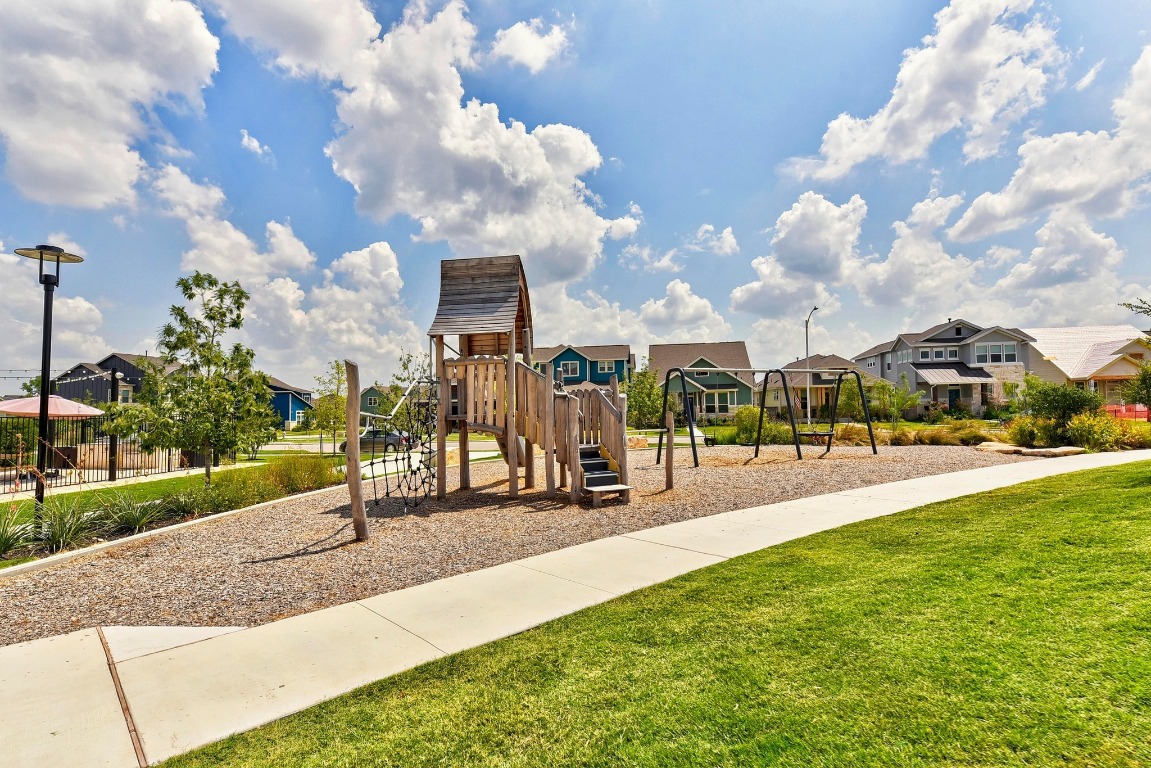 9015 Cattle Baron Path, Unit 1905 Austin, TX 78747 - Photo 36 of 40 a view of a park with swings and slides