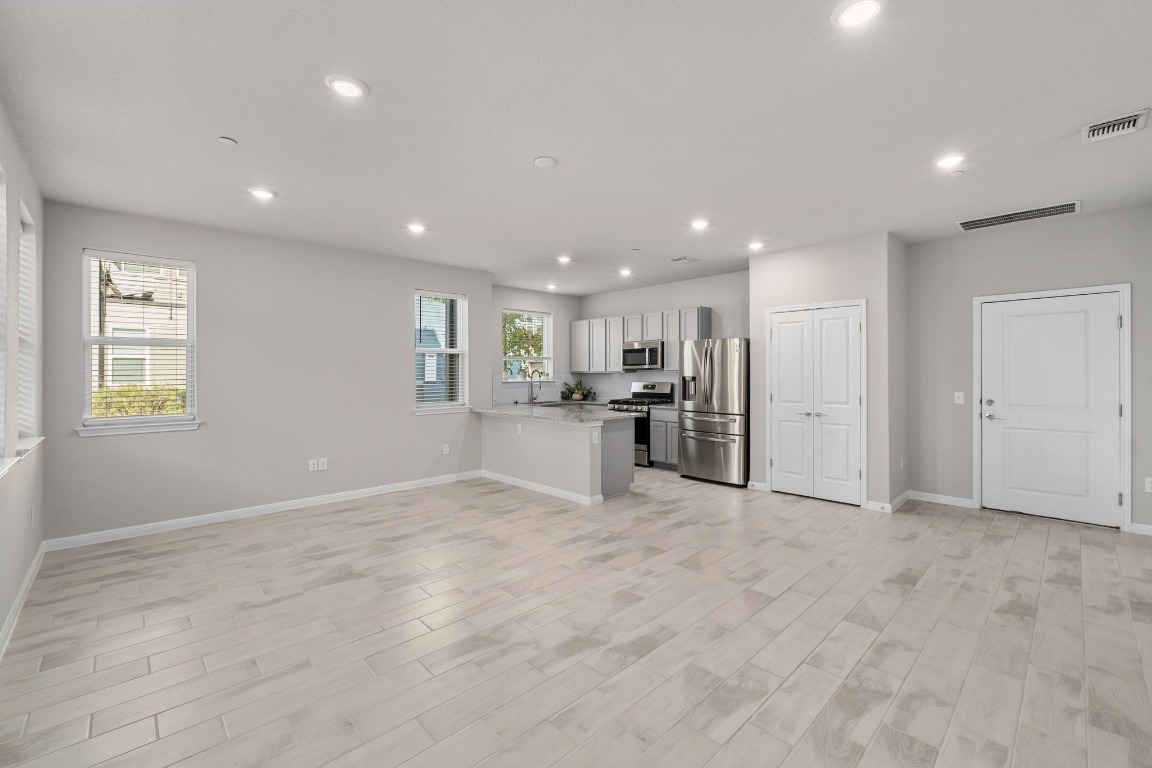 9015 Cattle Baron Path, Unit 1905 Austin, TX 78747 - Photo 4 of 40 a view of kitchen with refrigerator and windows