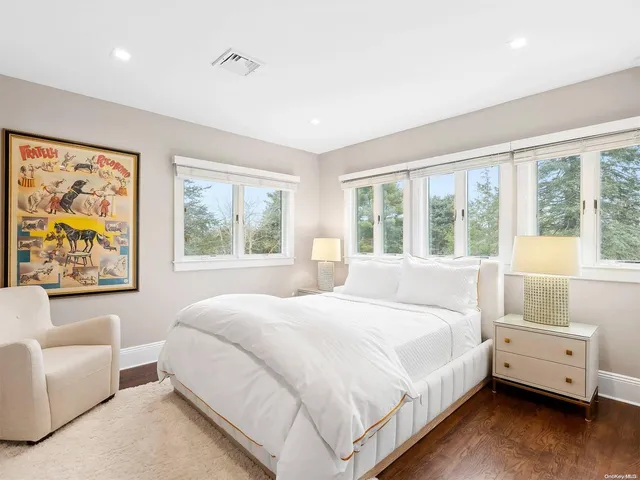 a bedroom with a large bed and a large window