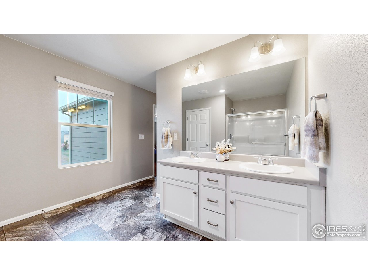 933 Keneally Court Windsor, CO 80550 - Photo 12 of 40 a bathroom with a sink double vanity and a mirror