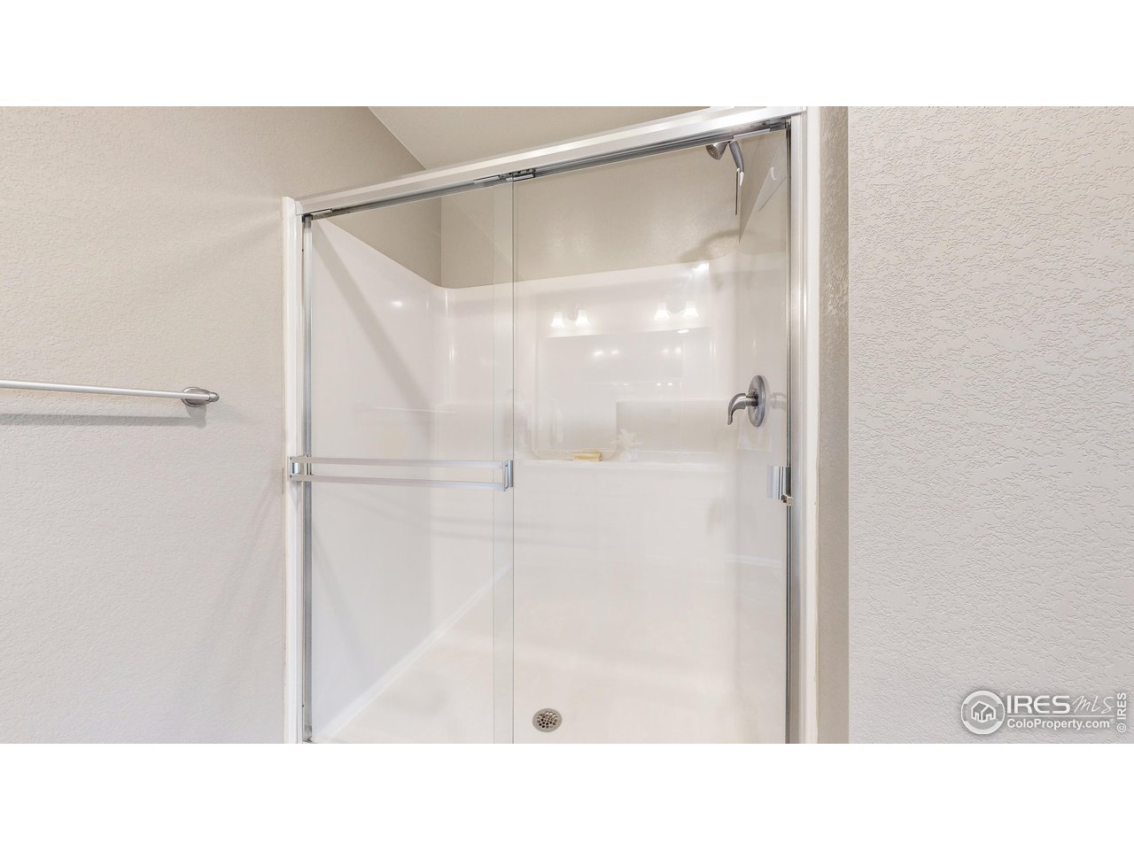 933 Keneally Court Windsor, CO 80550 - Photo 13 of 40 a bathroom with a shower and a glass shower door