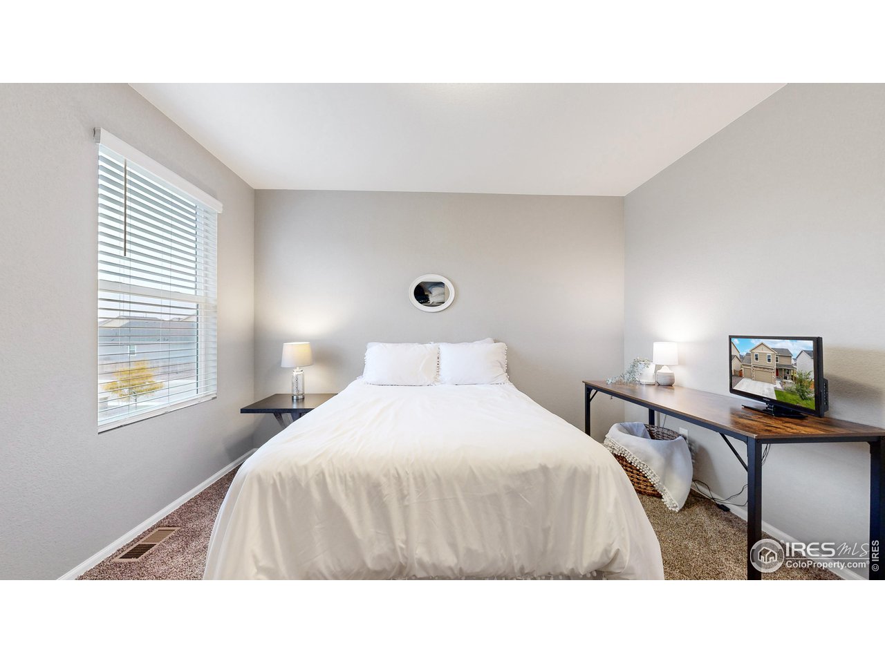 933 Keneally Court Windsor, CO 80550 - Photo 18 of 40 a bedroom with a bed and a window