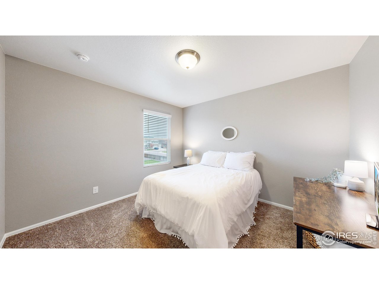 933 Keneally Court Windsor, CO 80550 - Photo 19 of 40 a bedroom with a bed and a night stand