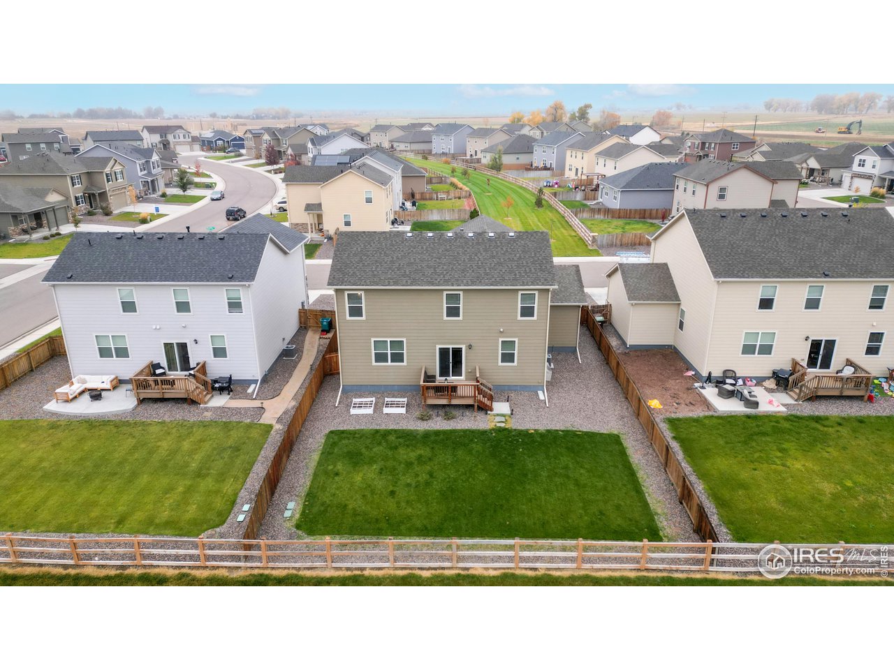 933 Keneally Court Windsor, CO 80550 - Photo 30 of 40 an aerial view of a house with a garden and houses