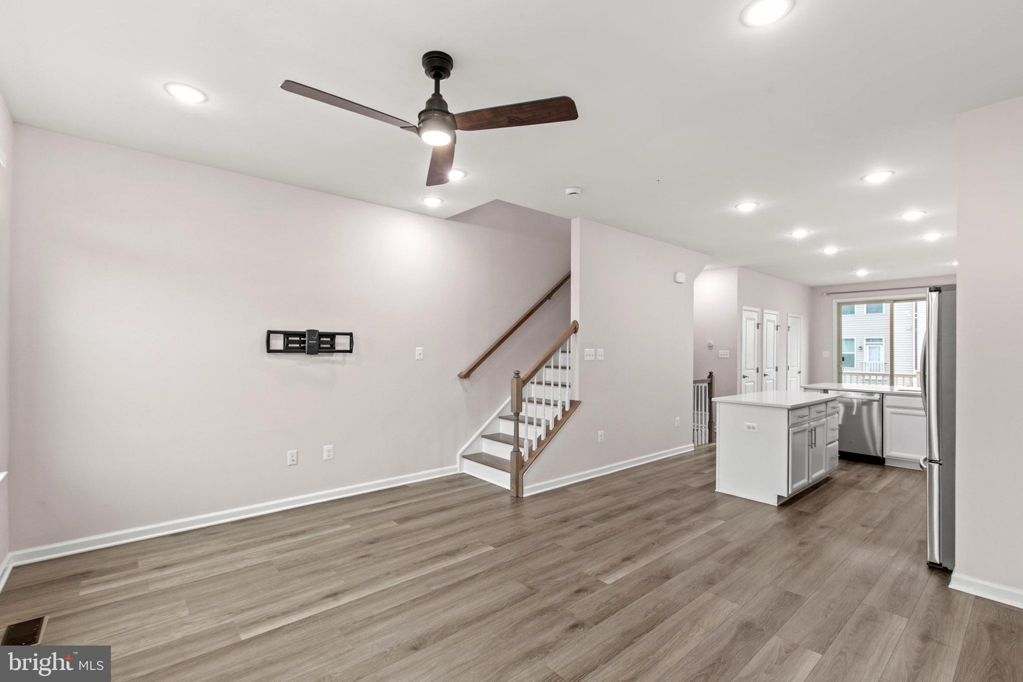 3753 Valley Ford Way Hanover, MD 21076 - Photo 14 of 35 a view of an empty room with wooden floor and a ceiling fan