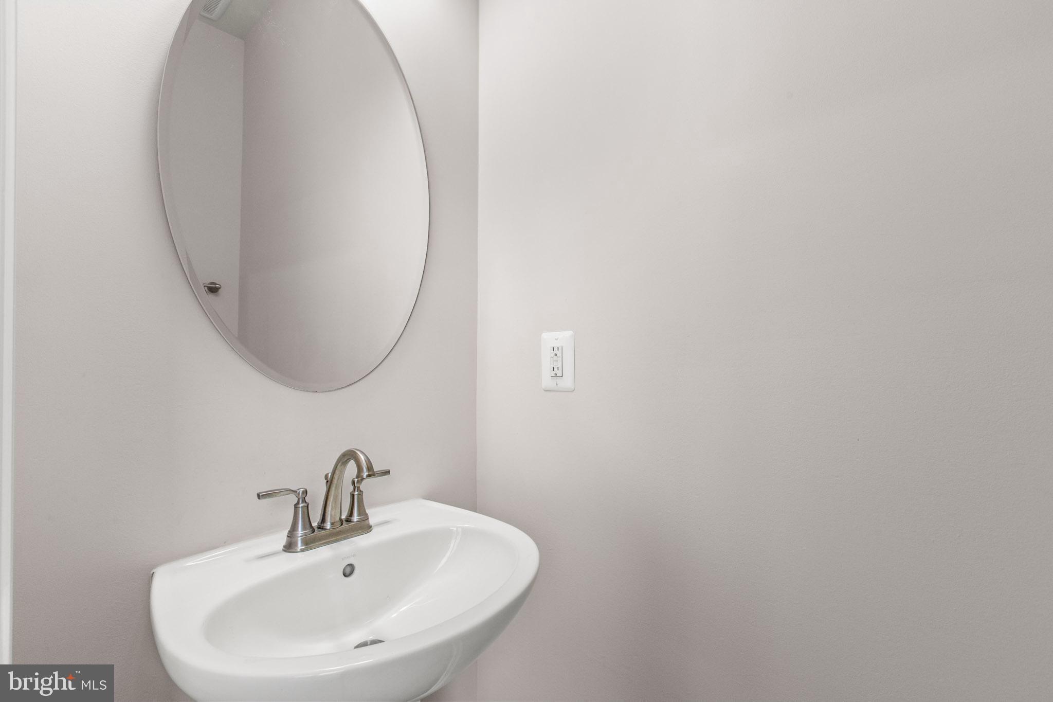 3753 Valley Ford Way Hanover, MD 21076 - Photo 16 of 35 a bathroom with a sink and a mirror