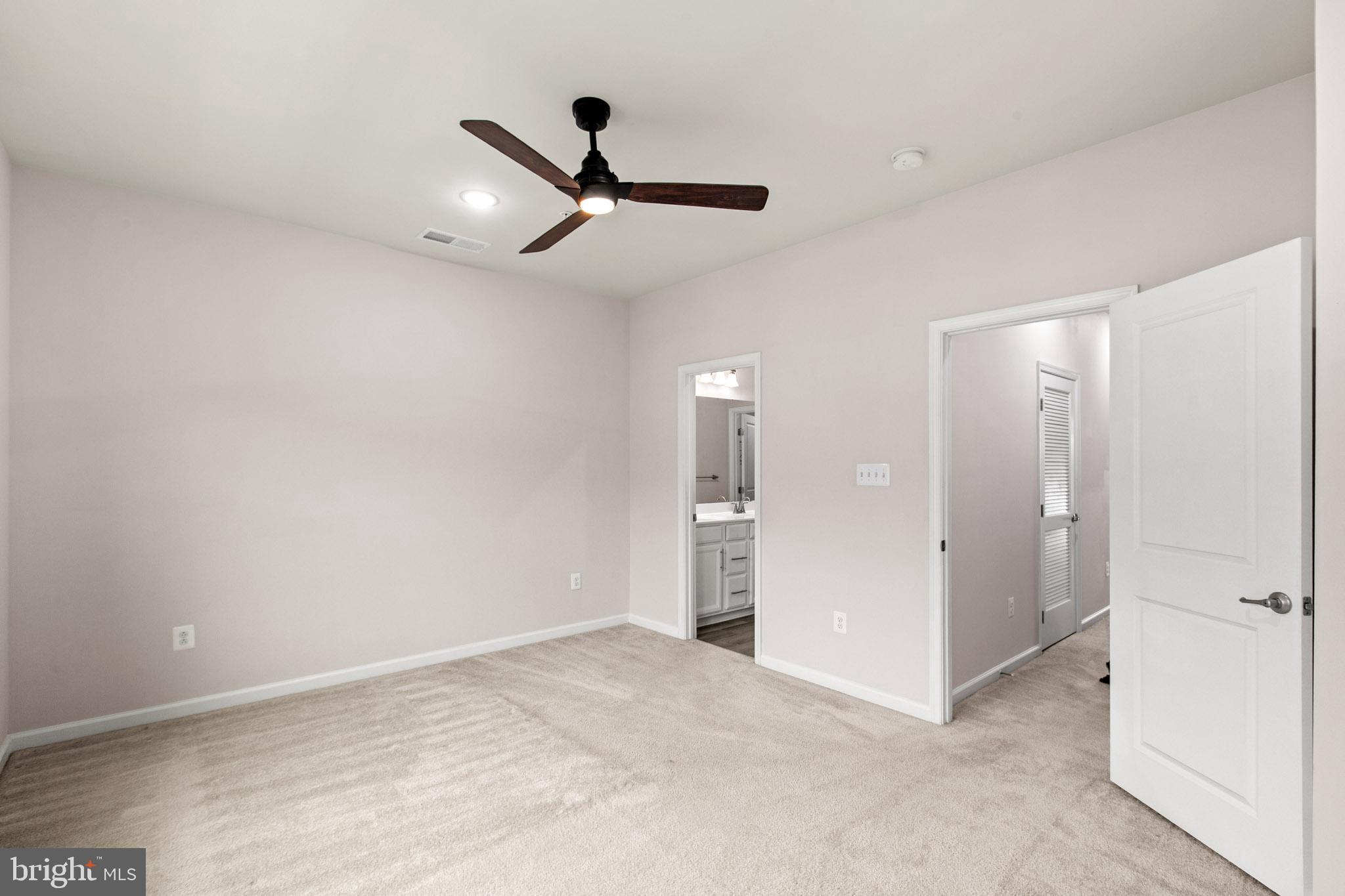 3753 Valley Ford Way Hanover, MD 21076 - Photo 18 of 35 a view of a livingroom with a ceiling fan & entryway