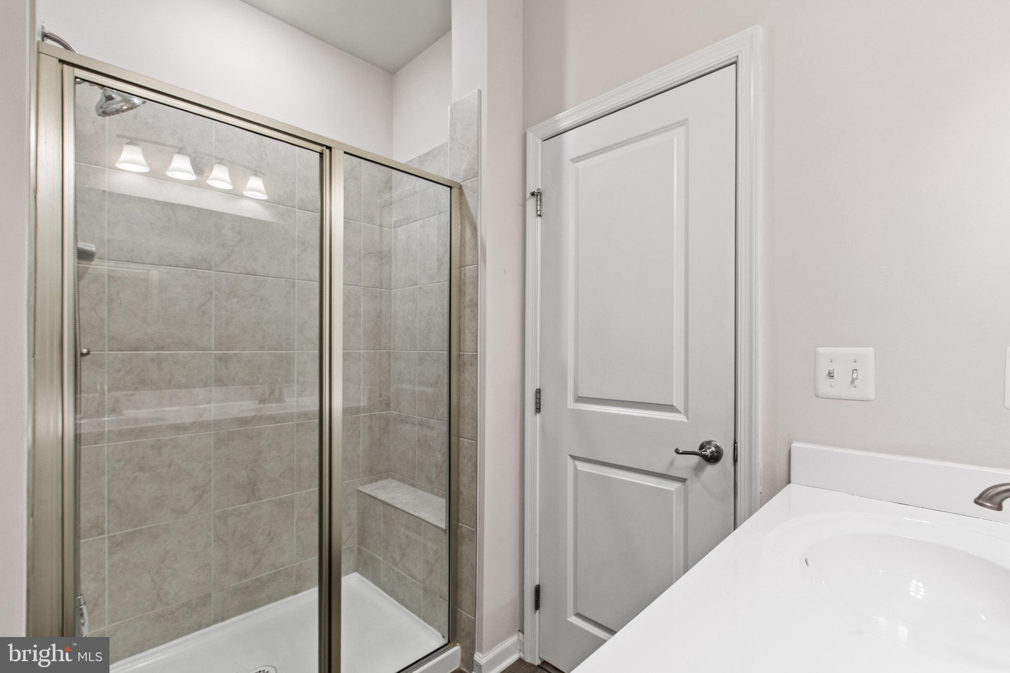 3753 Valley Ford Way Hanover, MD 21076 - Photo 20 of 35 a bathroom with a shower and a glass door
