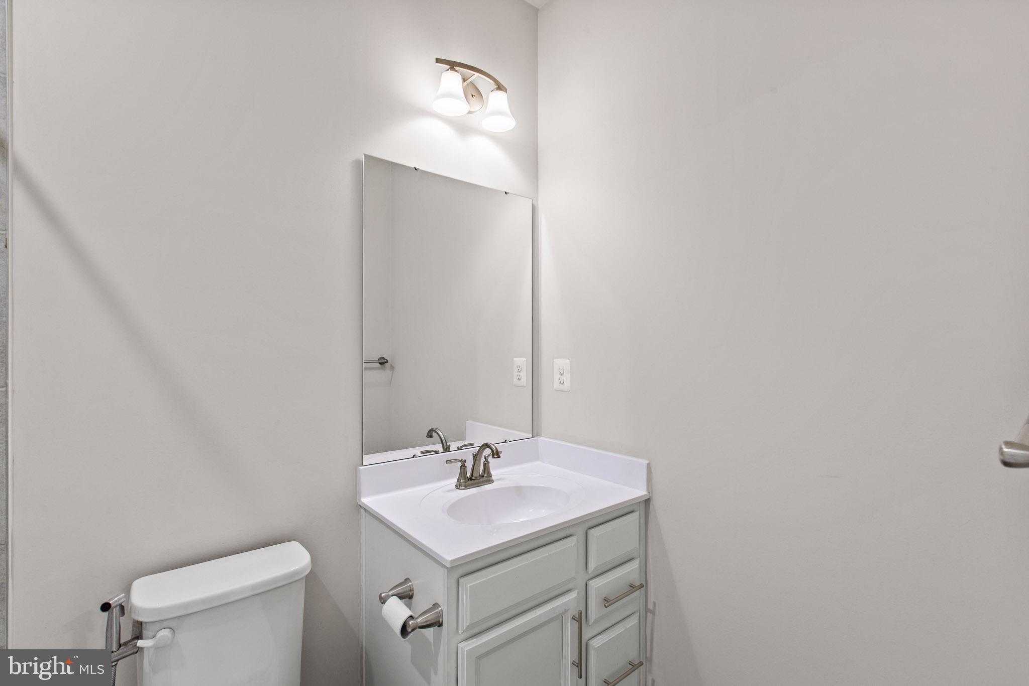 3753 Valley Ford Way Hanover, MD 21076 - Photo 25 of 35 a bathroom with a sink a toilet and a mirror
