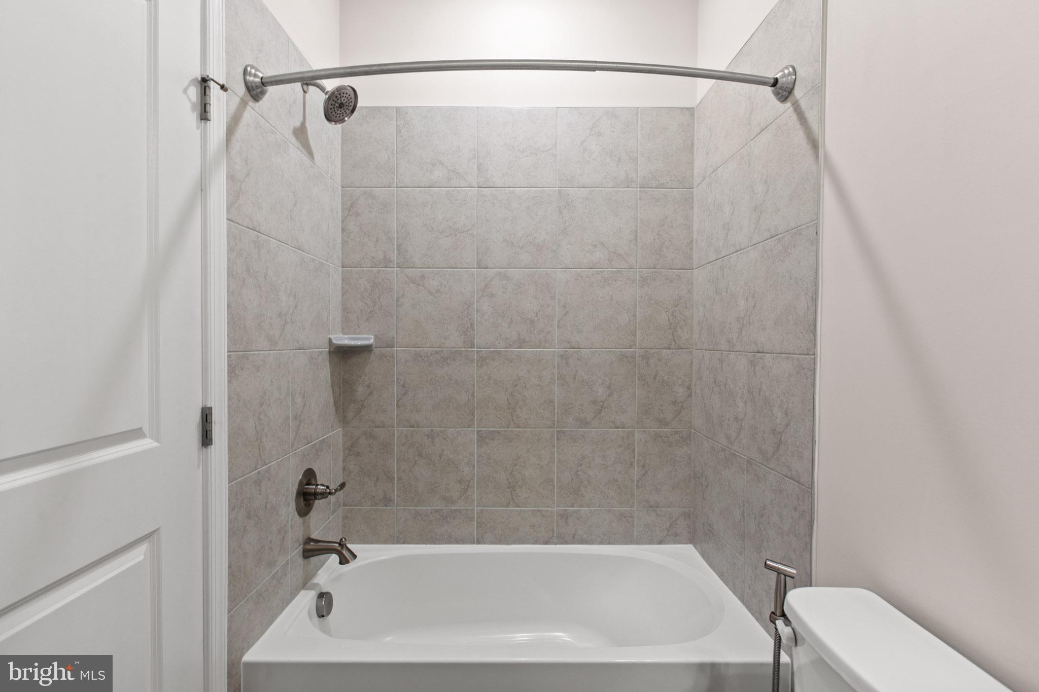 3753 Valley Ford Way Hanover, MD 21076 - Photo 26 of 35 a bathroom with a shower and a bath tub