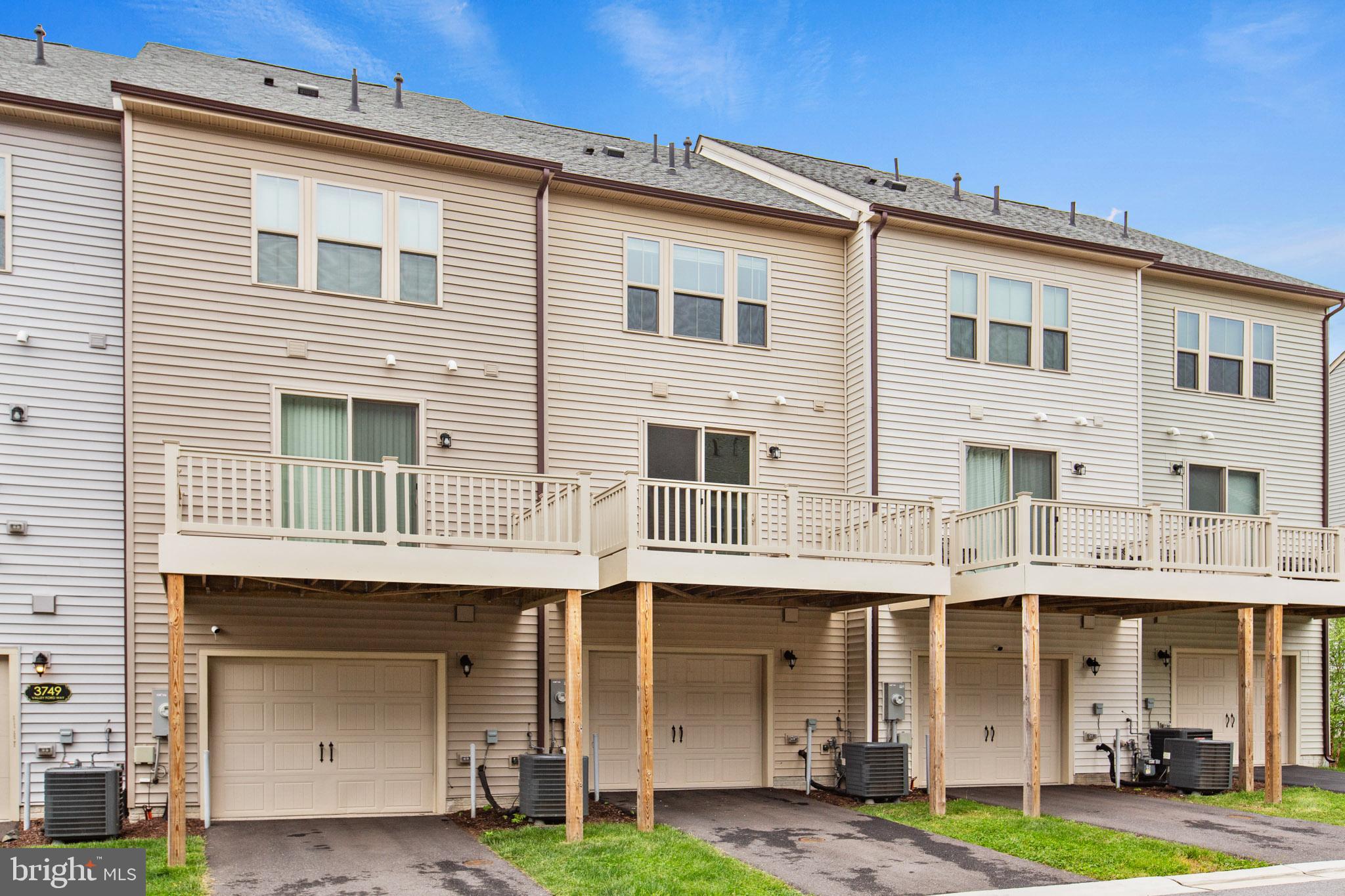 3753 Valley Ford Way Hanover, MD 21076 - Photo 29 of 35 a front view of a residential apartment building with a yard