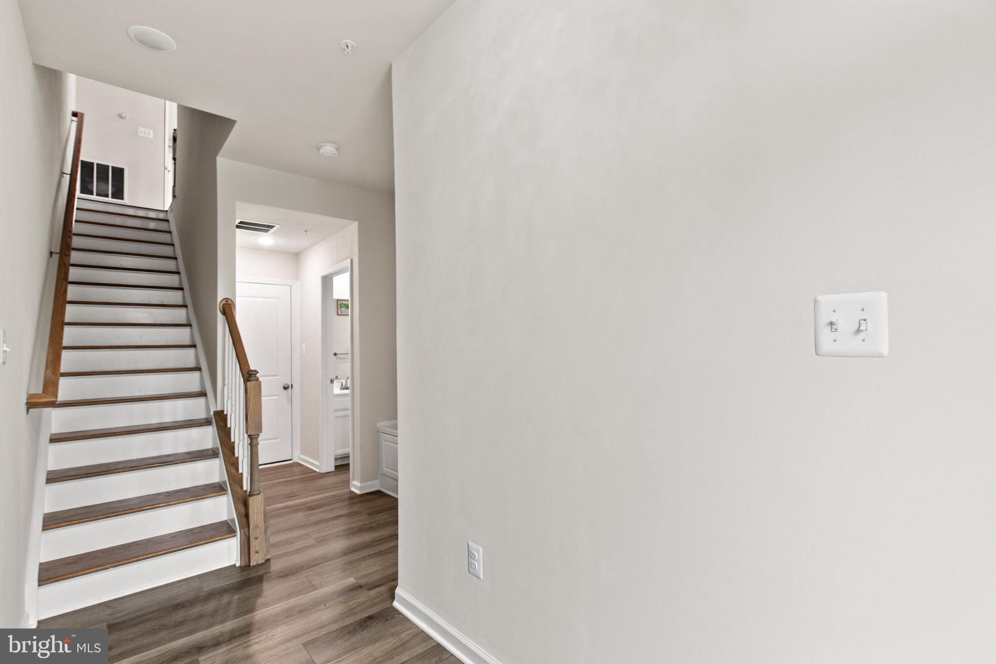3753 Valley Ford Way Hanover, MD 21076 - Photo 4 of 35 a view of a hallway with wooden floor and entryway