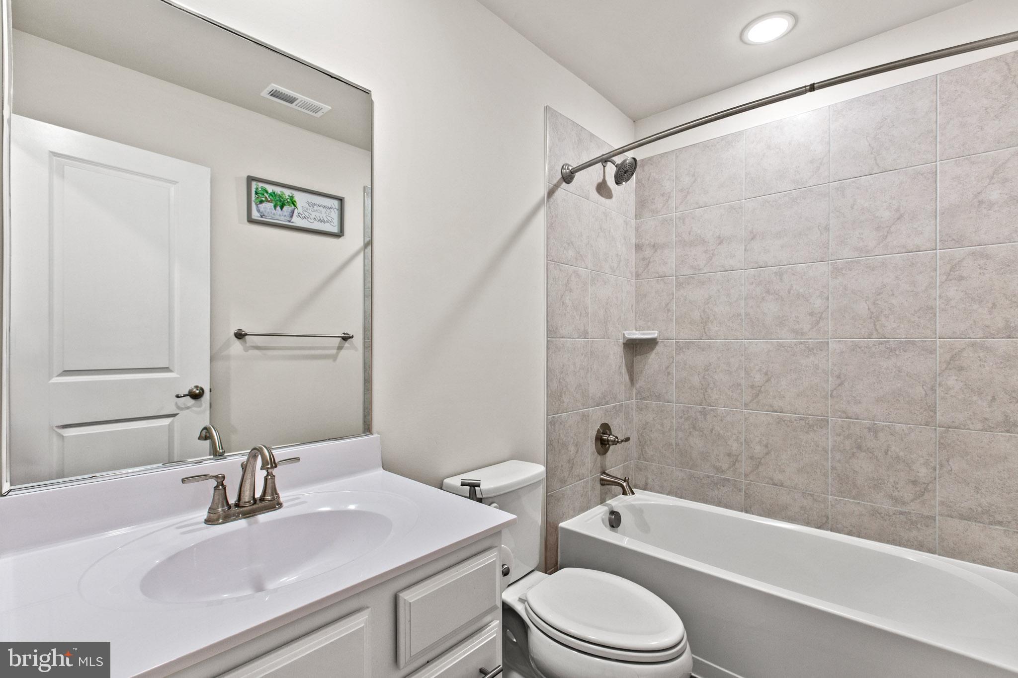 3753 Valley Ford Way Hanover, MD 21076 - Photo 8 of 35 a bathroom with a sink a toilet and a bathtub