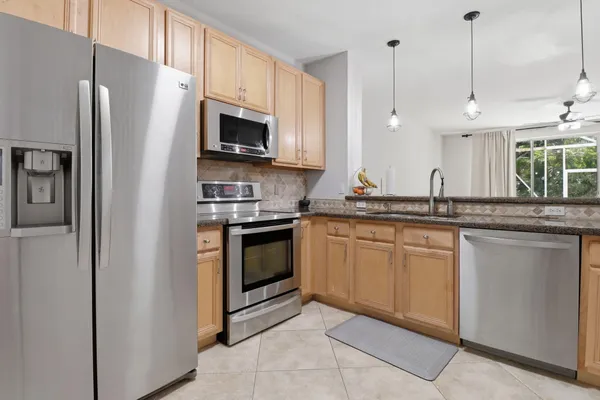 a view of kitchen with microwave and cabinets