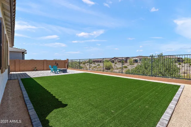 a view of a green field with an ocean view
