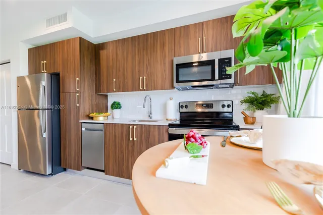 a kitchen with a refrigerator a stove and a microwave