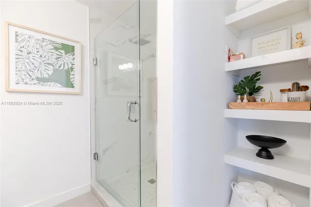 a picture of a bathroom with a shower and a sink