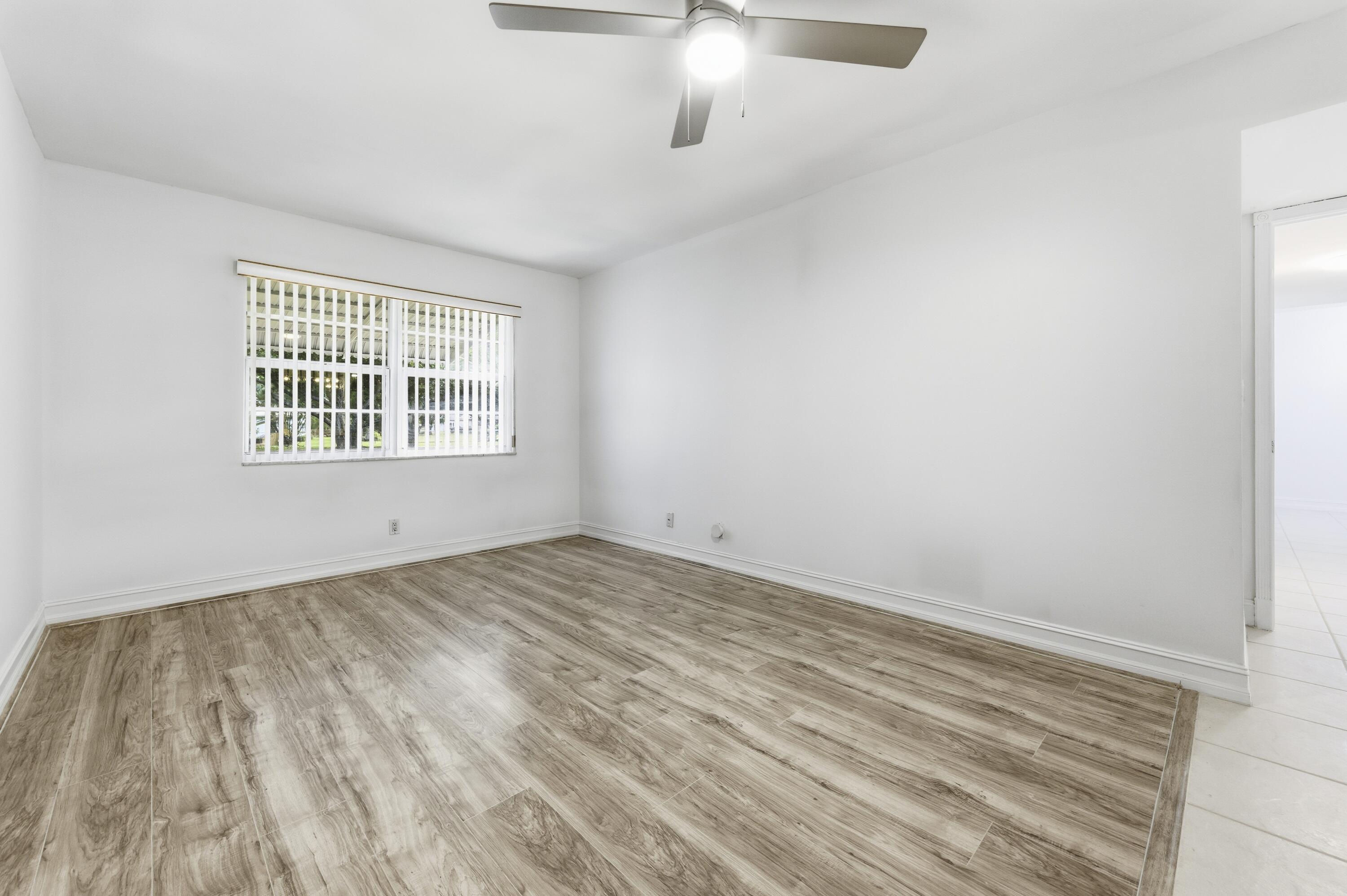 1167 South Drive Circle, Unit D Delray Beach, FL 33445 - Photo 16 of 26 an empty room with a window