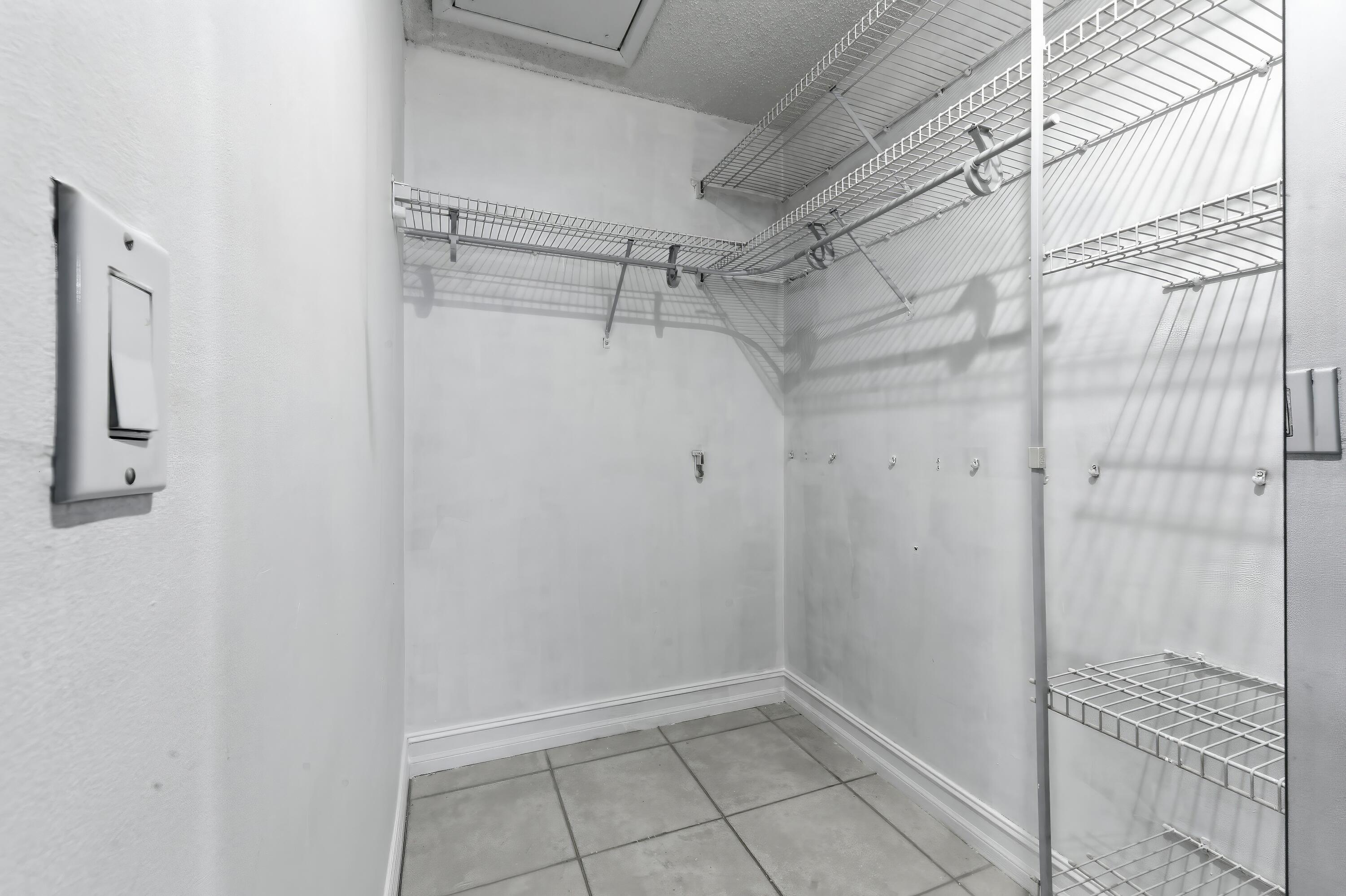 1167 South Drive Circle, Unit D Delray Beach, FL 33445 - Photo 19 of 26 a bathroom with a glass shower door