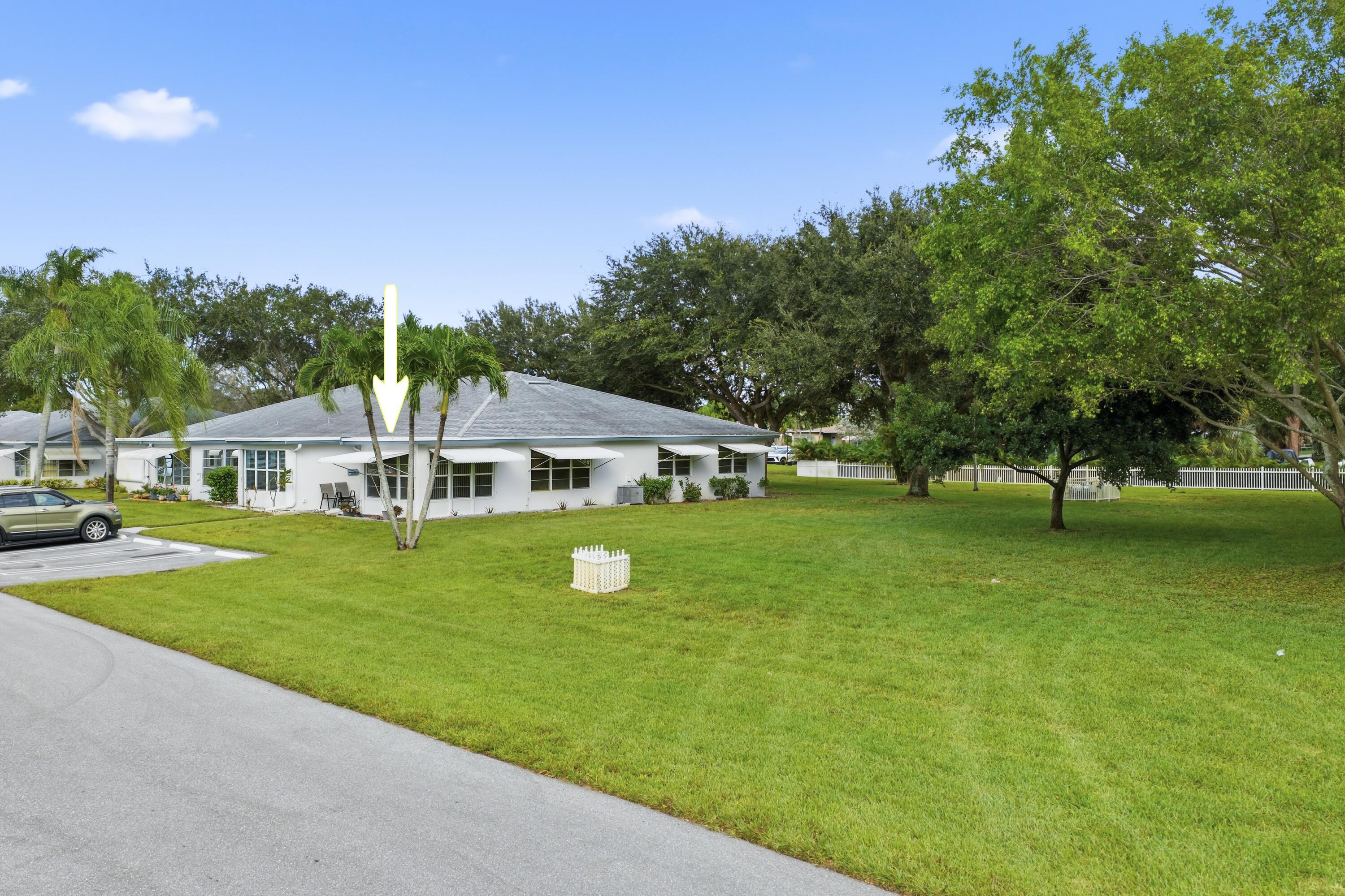 1167 South Drive Circle, Unit D Delray Beach, FL 33445 - Photo 20 of 26 a front view of a house with a garden