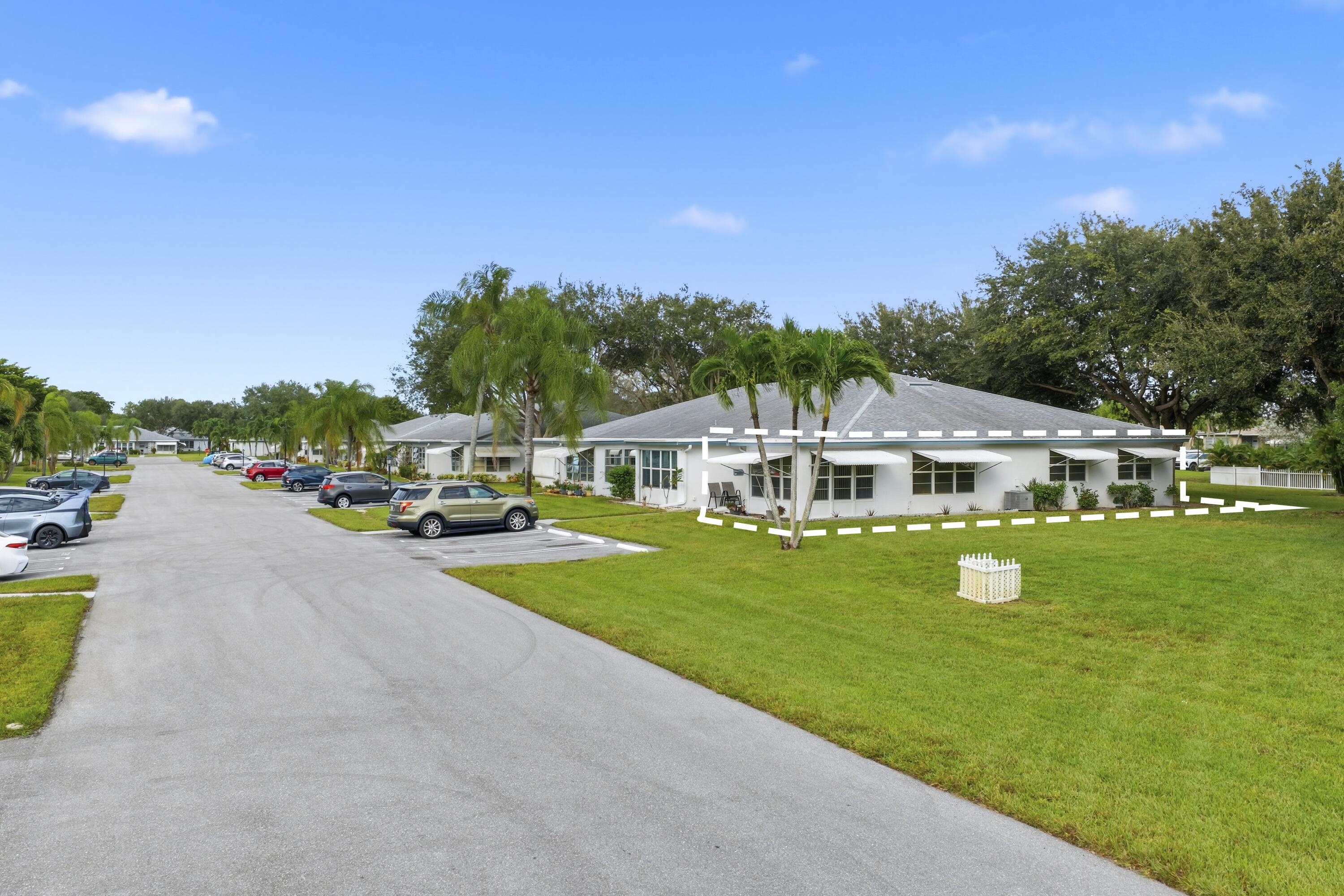 1167 South Drive Circle, Unit D Delray Beach, FL 33445 - Photo 21 of 26 a front view of a house with garden