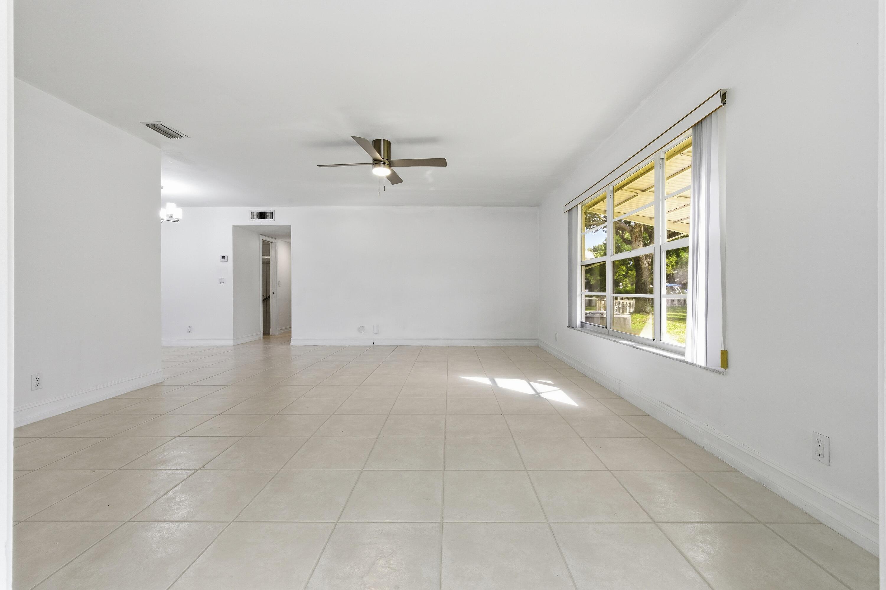 1167 South Drive Circle, Unit D Delray Beach, FL 33445 - Photo 5 of 26 a view of an empty room with a window
