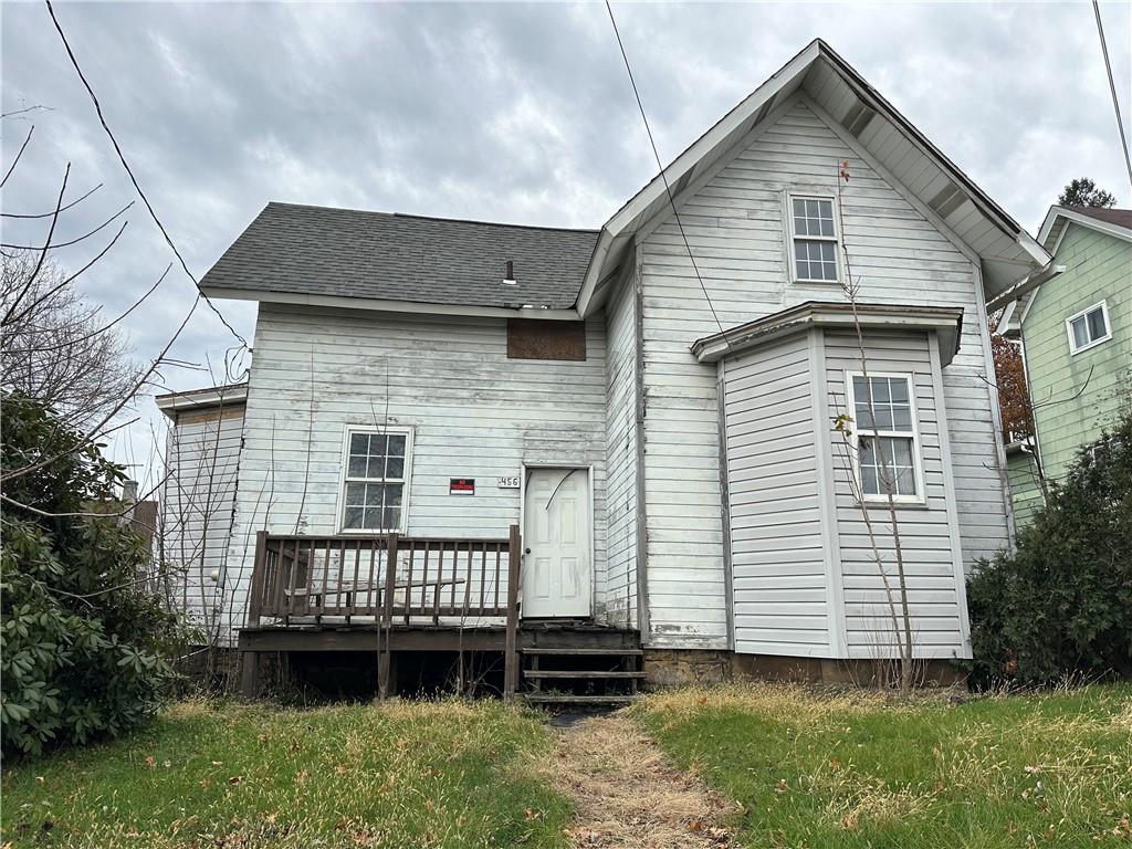 a view of a house with a yard and stairs