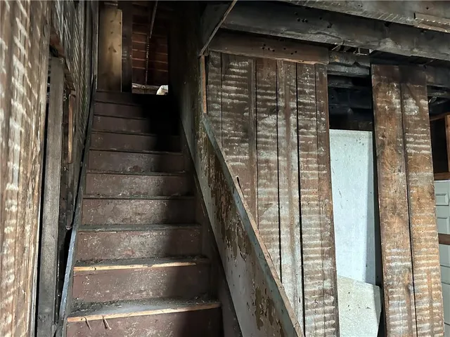 a view of staircase with white walls and windows