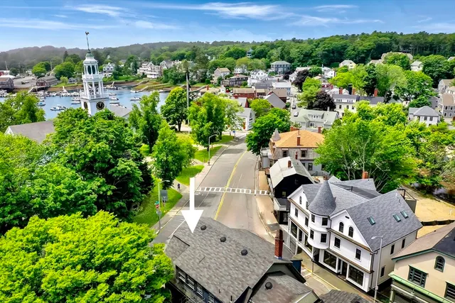 a aerial view of a house with a yard and lake view