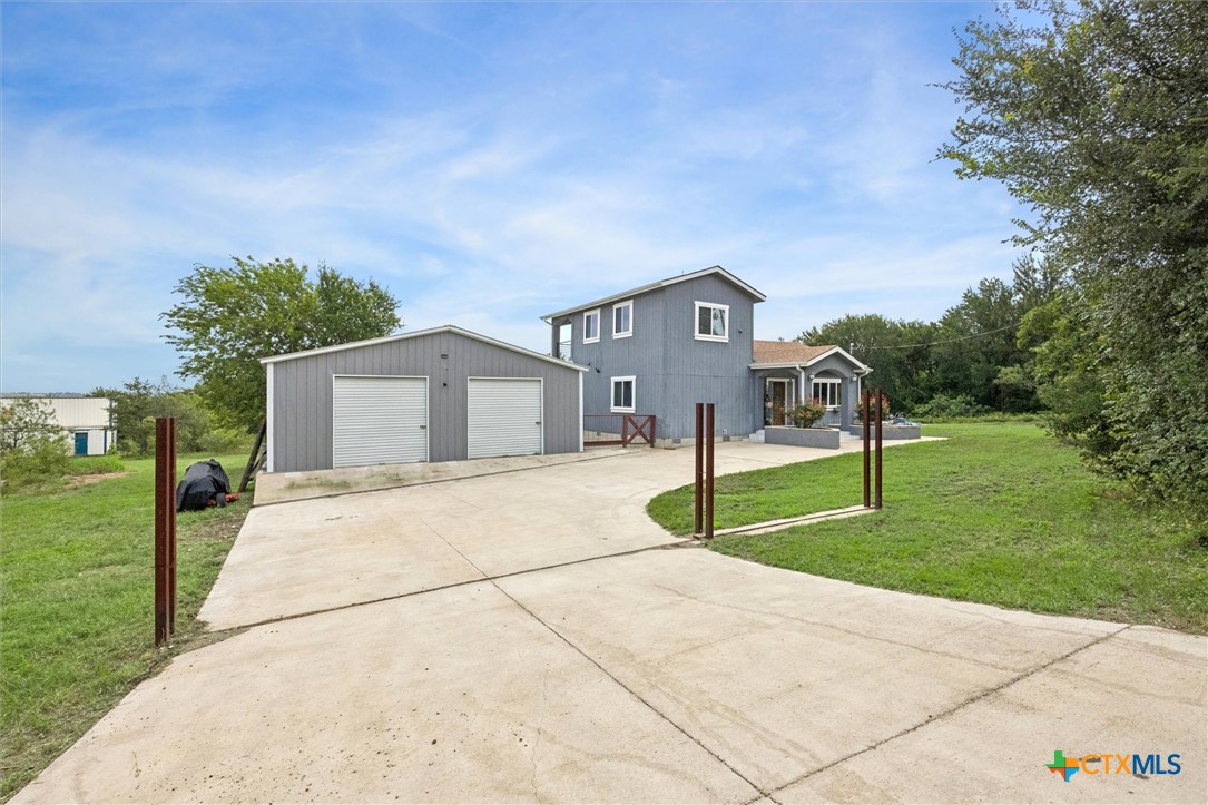 ENTRANCE TO HOUSE WITH DETACHED GARAGE