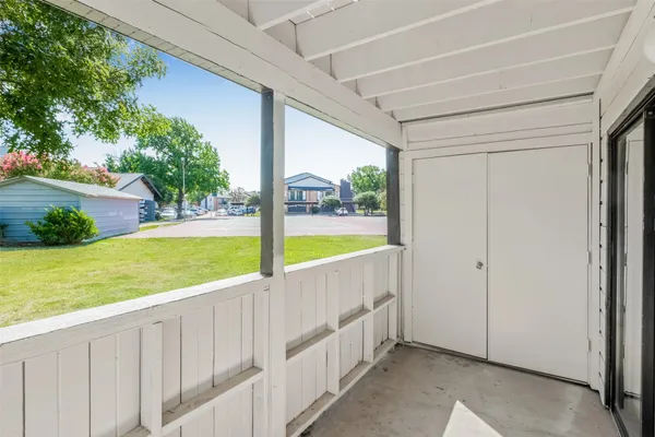 a view of a backyard with wooden fence