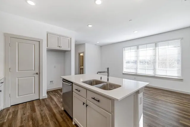 a view of kitchen with wooden floor and electronic appliances