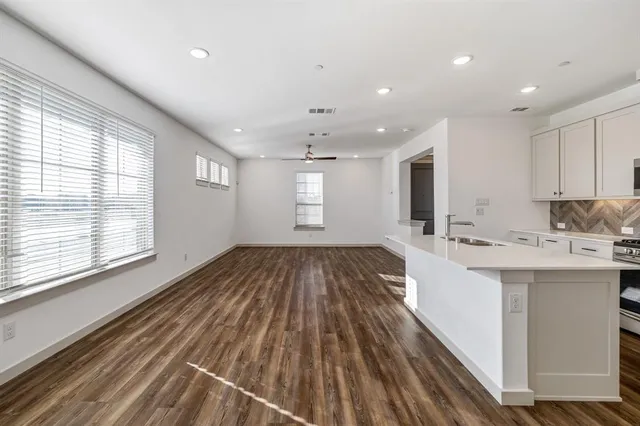 a kitchen with stainless steel appliances granite countertop a sink stove and cabinets