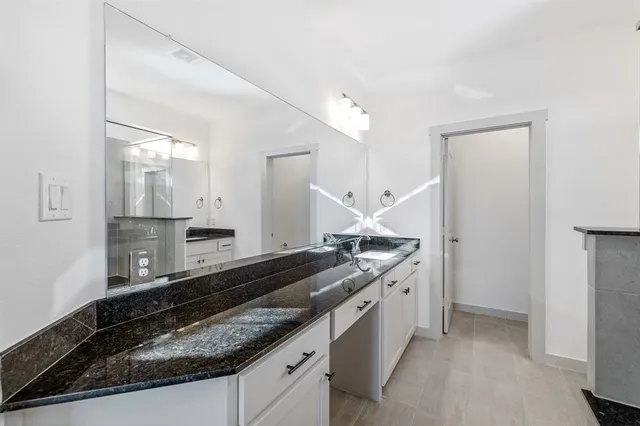 a bathroom with a shower and a sink